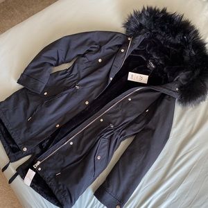 Beautiful faux-fur lined black jacket with removable hood and cinchable waist